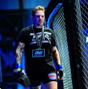 M M A Fighter Beside Cage Octagon Wallpaper