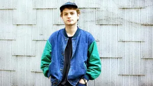 Mac De Marco Casual Pose Against Wall Wallpaper