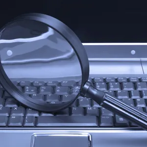 Magnifying Glass And A Laptop Wallpaper