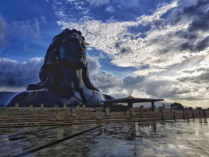 Majestic Adiyogi Shiva Statue In Tranquil Surroundings Wallpaper