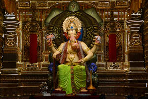 Majestic Lalbaugcha Raja Sitting On Turtle Throne Wallpaper