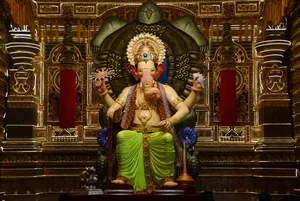 Majestic Lalbaugcha Raja Sitting On Turtle Throne Wallpaper