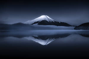 Majestic Mountain Peak Under A Twilight Sky Wallpaper