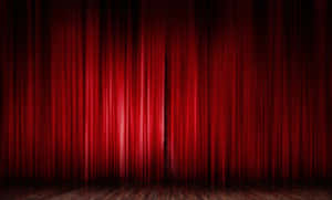 Majestic Red Curtains Of A Closed Theatre Stage Wallpaper