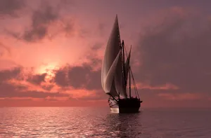 Majestic Sailboat Cruising On Crystal Clear Waters Wallpaper