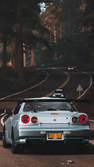 Majestic Silver Nissan Skyline Glinting In The Sun Wallpaper