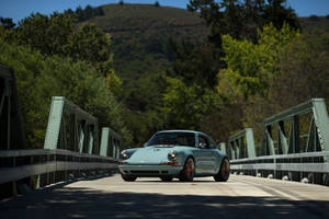 Majestic Singer Porsche Awaiting Adventure On The Bridge Wallpaper
