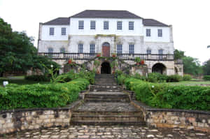 Majestic View Of Rose Hall Great House Under The Clear White Sky Wallpaper