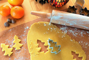 Making Christmas Tree Cookies For Holiday Celebration Wallpaper