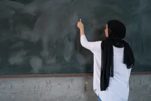 Malaysian Teacher Writing On Blackboard Wallpaper