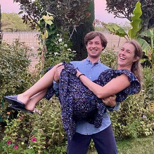 Man Carrying Womanin Garden Wallpaper