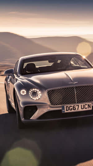 Man Driving A Bentley Iphone Wallpaper