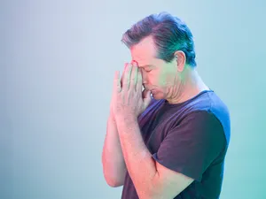 Man Experiencing Discomfortor Stress Wallpaper
