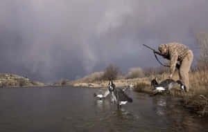 Man In Hunting Camo Petting Duck Wallpaper