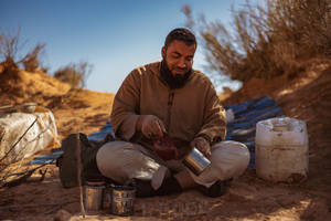 Man Making Coffee In Libya Wallpaper