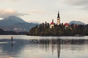 Man Paddling At Lake Bled Wallpaper