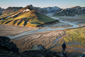 Man Standing On The Edge Of A Cliff Wallpaper