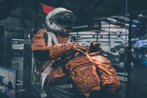 Man Wearing Brown Astronaut Suit Wallpaper