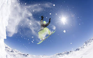 Man With Snowboard Posing Mid-trick Wallpaper