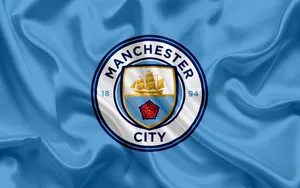 Manchester City Logo On Blue Cloth Wallpaper