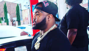 Manin Black Capand Gold Chain Wallpaper