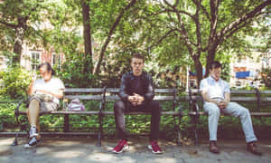 Manin Black Leather Jacketon Park Bench Wallpaper