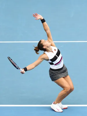 Maria Sakkari Hitting Tennis Ball To Serve Wallpaper