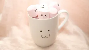 Marshmallows In A Cup With Faces On Them Wallpaper