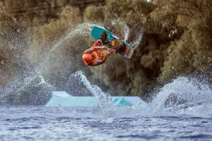 Mastering The Tootsie Roll Trick In Wakeboarding Wallpaper