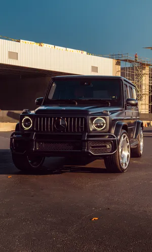 Matte Black Luxury S U V Parked Outdoors Wallpaper