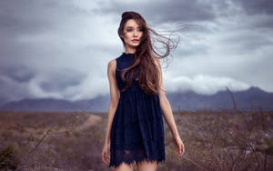 Mature Woman In The Stormy Desert Wallpaper