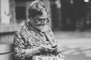 Mature Woman Texting On Her Cell Phone Wallpaper