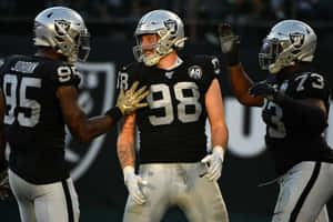 Maxx Crosby Celebrating With Raiders Teammates. Wallpaper