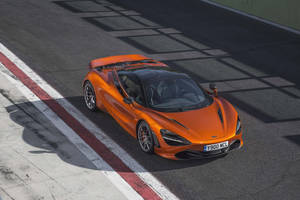 Mclaren 720s 4k On A Road Wallpaper