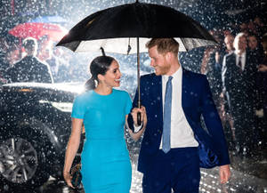 Meghan Markle And Prince Harry Strolling In The Rain Wallpaper