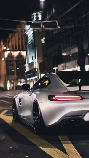 Mercedes Amg Gtr Against City Lights Wallpaper