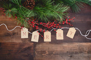 Merry Text Cutout On White String By Wreath Wallpaper