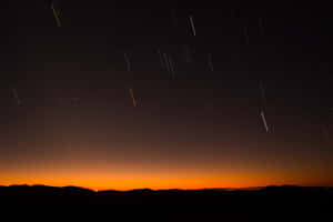 Meteor Shower In The Night Sky Wallpaper