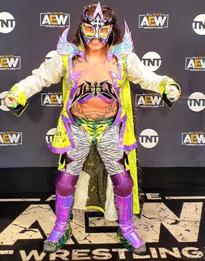 Mexican Pro-wrestler Juventud Guerrera Dazzles On Aew Red Carpet In Vibrant Costume Wallpaper