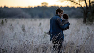 Michael Shannon With Kid On Grassland Wallpaper