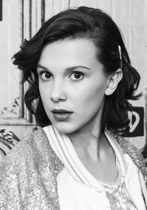 Millie Bobby Brown Strikes A Pose In A Black Ensemble Wallpaper