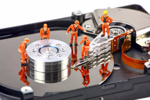 Miniature Workers Repairing Hard Drive Disk Wallpaper