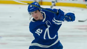 Mitchell Marner Hitting A Puck Wallpaper