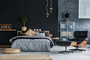 Modern Black Lounging Chair In Elegant Bedroom Wallpaper