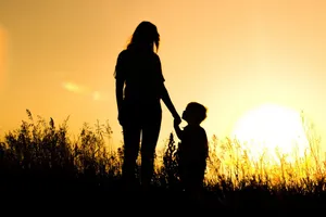 Mom And Son Silhouette In Sunlight Wallpaper