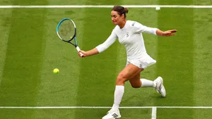 Monica Niculescu In Action, Wearing A White Tennis Outfit. Wallpaper