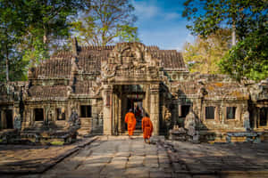 Monks In Serenity: A Peaceful Walk In Angkor Thom Wallpaper