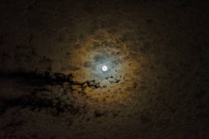 Moonlit Clouds Illuminated Against The Night Sky Wallpaper