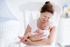Mother Cradling Baby Love Wallpaper