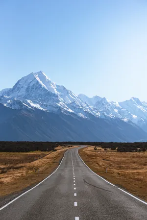 Mountains Covered With Snow Near Road Wallpaper